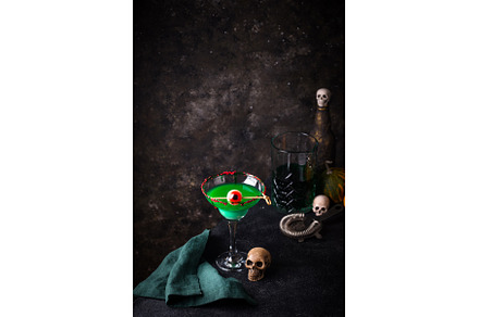 Eerie green Halloween cocktail with, a Food & Drink Photo by Yulia Furman