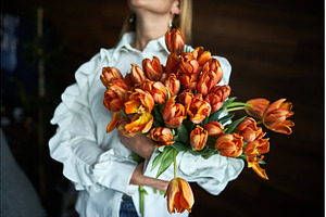 Elegant woman holding vibrant orange, a Beauty & Fashion Photo by wip3out