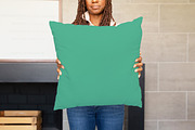 Black Model Holding Pillow Mockup, a Product Mockup by JENLYNN Stock Shop (Thumbnail 1 of 4)