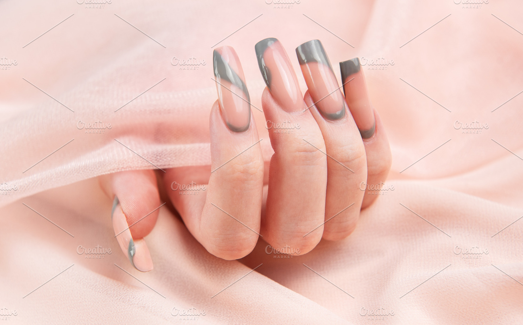 Female hand showing long square marble design nails, a Beauty & Fashion Photo by Olena Rudo
