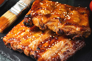 Barbecue pork spare ribs with hot honey chili marinade on black background, a Food & Drink Photo by Budarinphoto