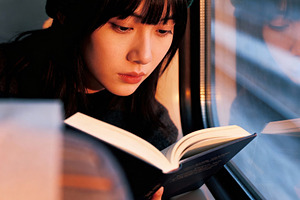 Young Woman Reading on a Train, a Person Photo by Virgo Studio