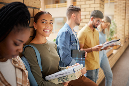 University, hallway and portrait of woman and students standing in row together with books at business school. Friends, education and future, happy woman in study group on campus in lobby for exam., a Photo by Peopleimages.com