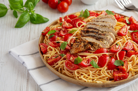 Homemade Bruschetta Chicken Pasta on a Plate, side view., a Food & Drink Photo by LiudmylaChuhunova