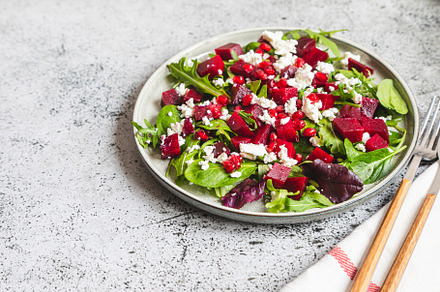 Arugula, Beet and cheese salad with pomegranate and dressing on, a Food & Drink Photo by Ivanna