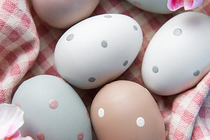 Pastel polka dot easter eggs in checkered basket, a Holiday Photo by Olena Rudo