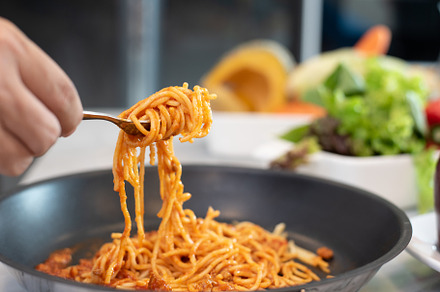 Spaghetti lifted by fork with vegetable salad and dish backgroun, a Food & Drink Photo by Ministocker
