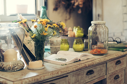 Jars with plant infusions featuring chamomile, honey, and lemon