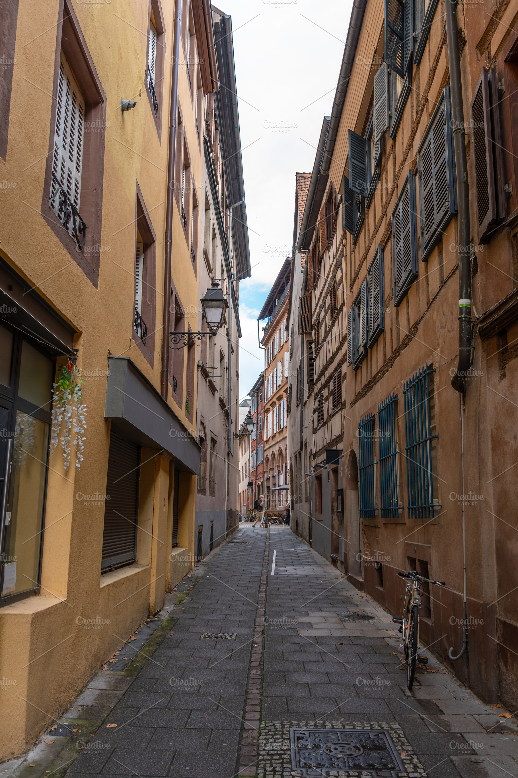 Narrow street with old houses in Strasbourg France, an Architecture Photo by GoodGoods