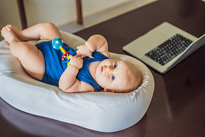 Curious infant exploring a rattle, a Person Photo by Elizaveta Galitskaya