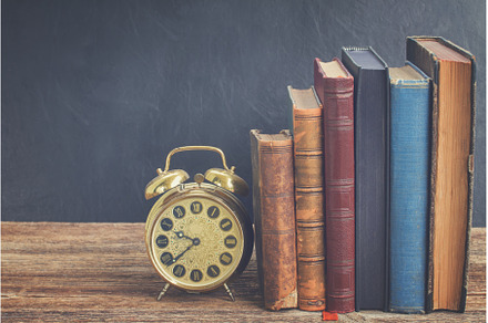 pile of books with clock, a School & Education Photo by Neirfy
