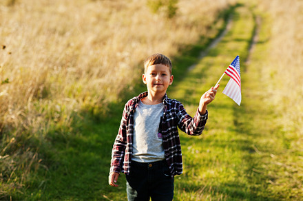 Little boy with USA flag outdoor. America celebrating., a Person Photo by AS photostudio
