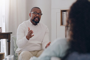 Therapy, support and psychologist talking to a woman about mental health, depression and anxiety. Psychology, healthcare and African therapist with advice for a patient while counseling in an office, a Photo by Peopleimages.com