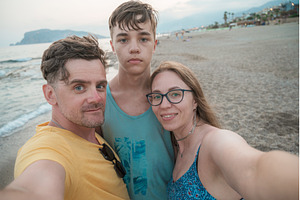 Happy family taking a photo, a Person Photo by Jan Jack Russo Media