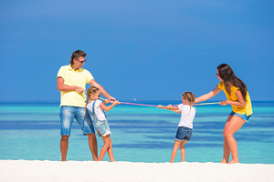 Happy family having fun on white beach stock photo containing adult and beach