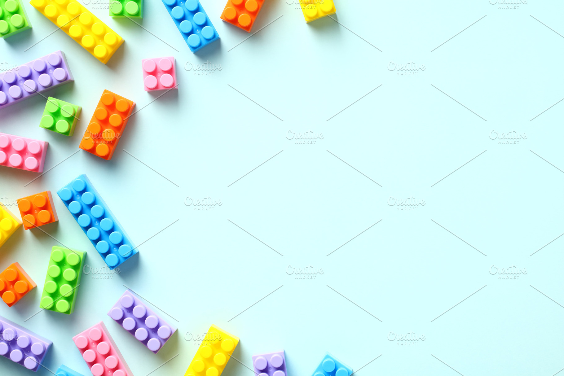 Colorful toy building blocks on pastel blue background. Baby educational game., a School & Education Photo by photoguns