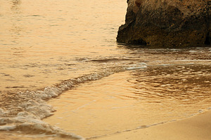 Soft sea waves rushing at the sunset