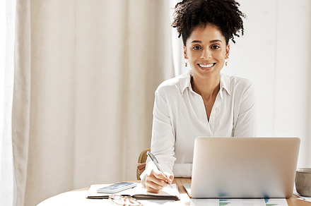 Notebook, laptop and portrait of business woman in office for mockup for management, planning and schedule. Vision, writing and smile with black woman employee for leadership, receptionist and agenda, a Photo by Peopleimages.com