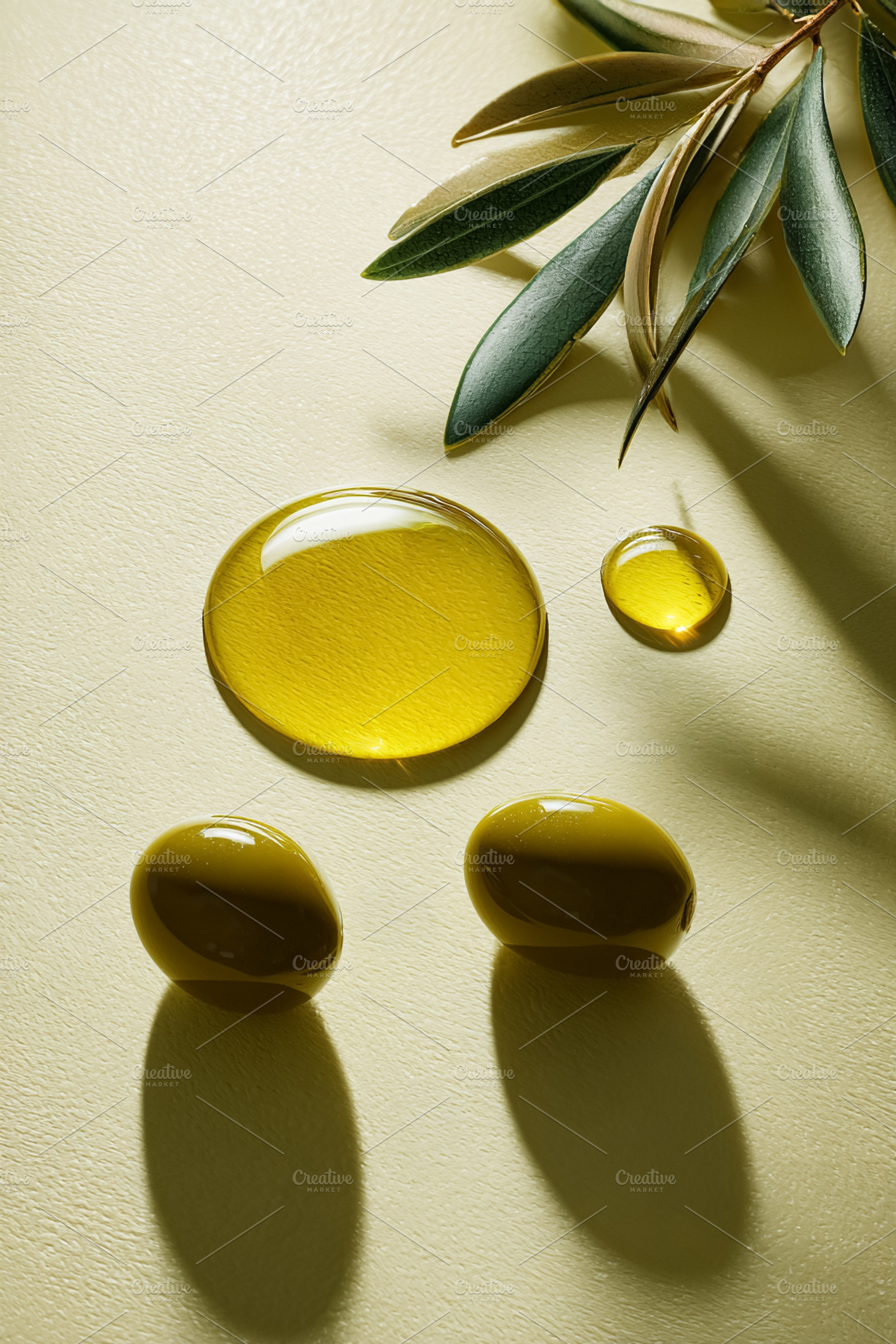 Virgin olive oil drops with fresh green olives and an olive bran, a Photo by Studio ANNA