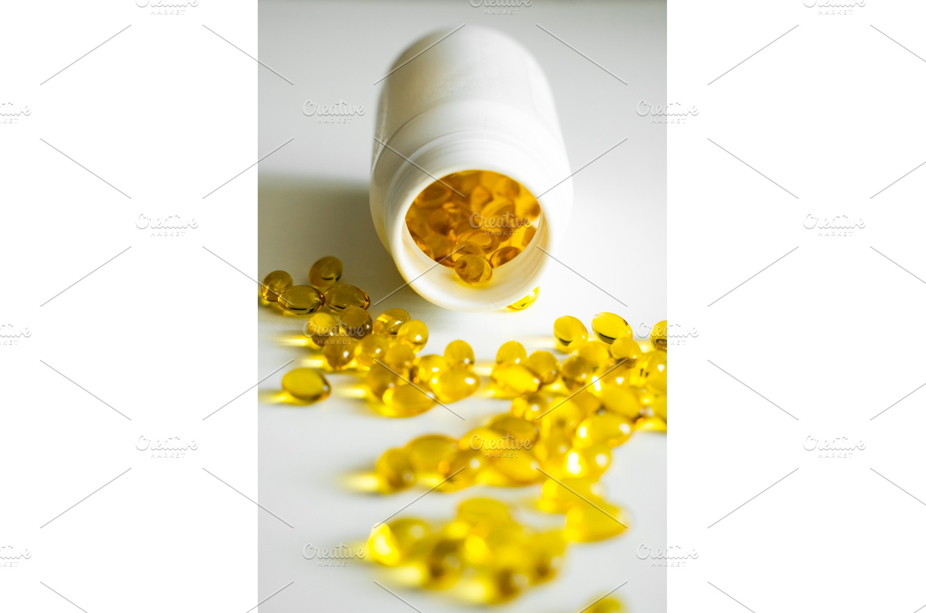 Yellow omega-3 capsules spread, a Health & Medical Photo by volodymyrshtun13795