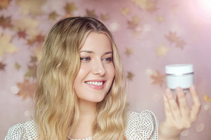 Woman with beautiful skin showing a new cosmetic cream for facia, a Person Photo by Studio ANNA