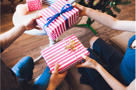 Couple giving gifts for each other, a Holiday Photo by Photo Drive Studio