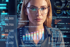 Professional female IT engineer (blonde woman in glasses) workin, a Technology Photo by Volff