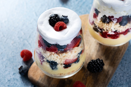 Trifle dessert with berries and cream on blue background, a Food & Drink Photo by etorres69