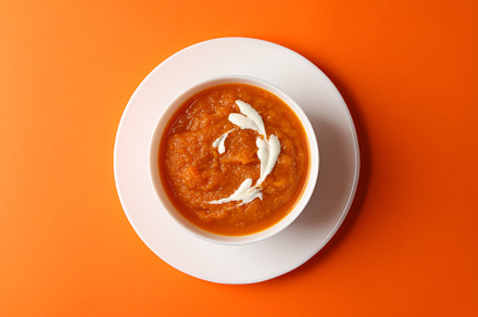 Bowl of pumpkin puree on orange background, top view, a Food & Drink Photo by AtlasStudio PRO