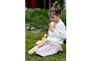 Smiling child playing with baby, an Animal Photo by HalfPoint