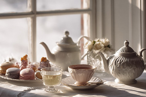 Afternoon tea party serving macarons, pastries, and hot beverage, a Photo by Studio ANNA