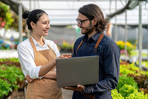 Greenhouse Workers Using Laptop Together, a Business Photo by Davizro's Market