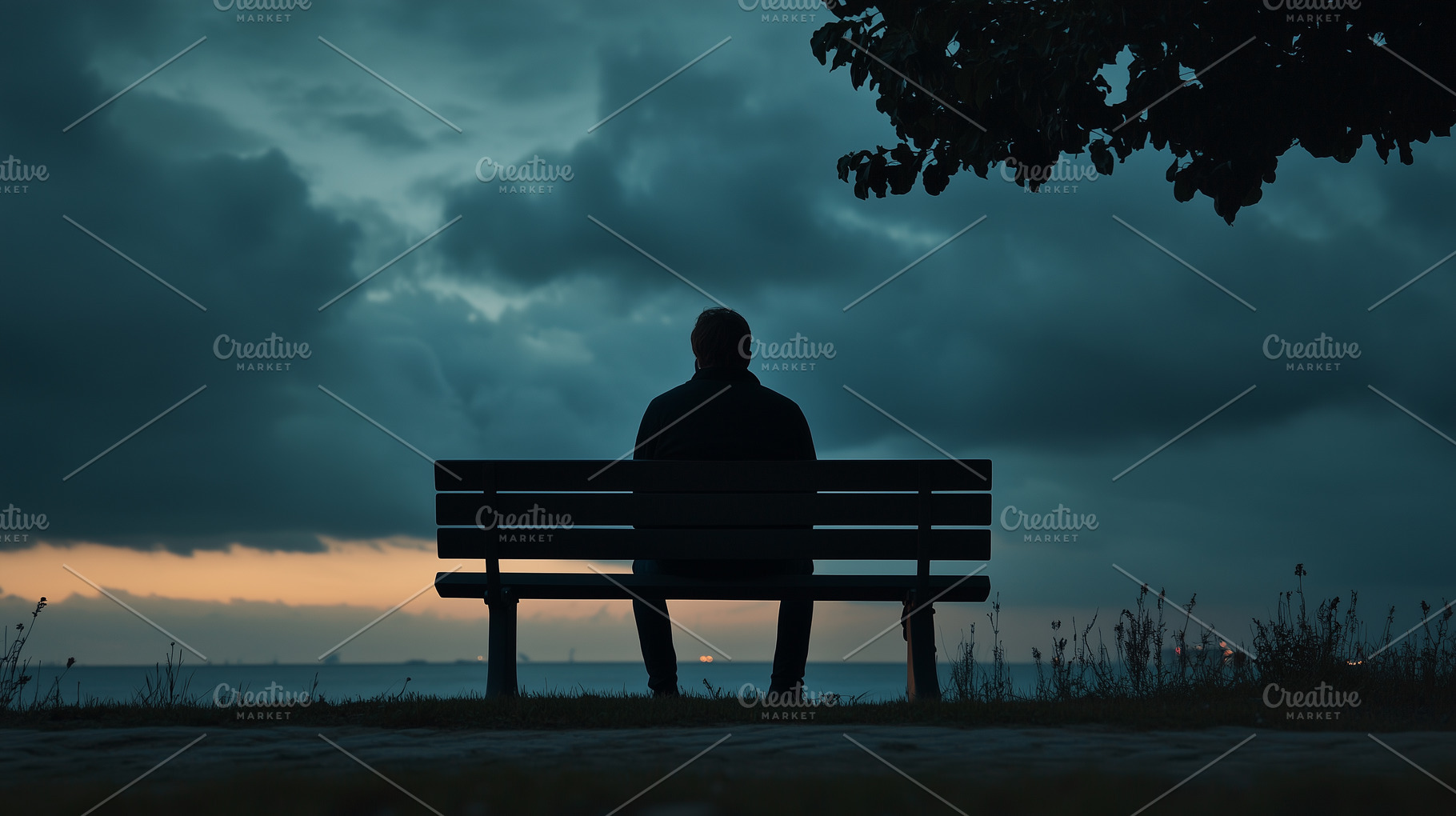 Man sits alone on a bench facing the, a Person Photo by MistyDay