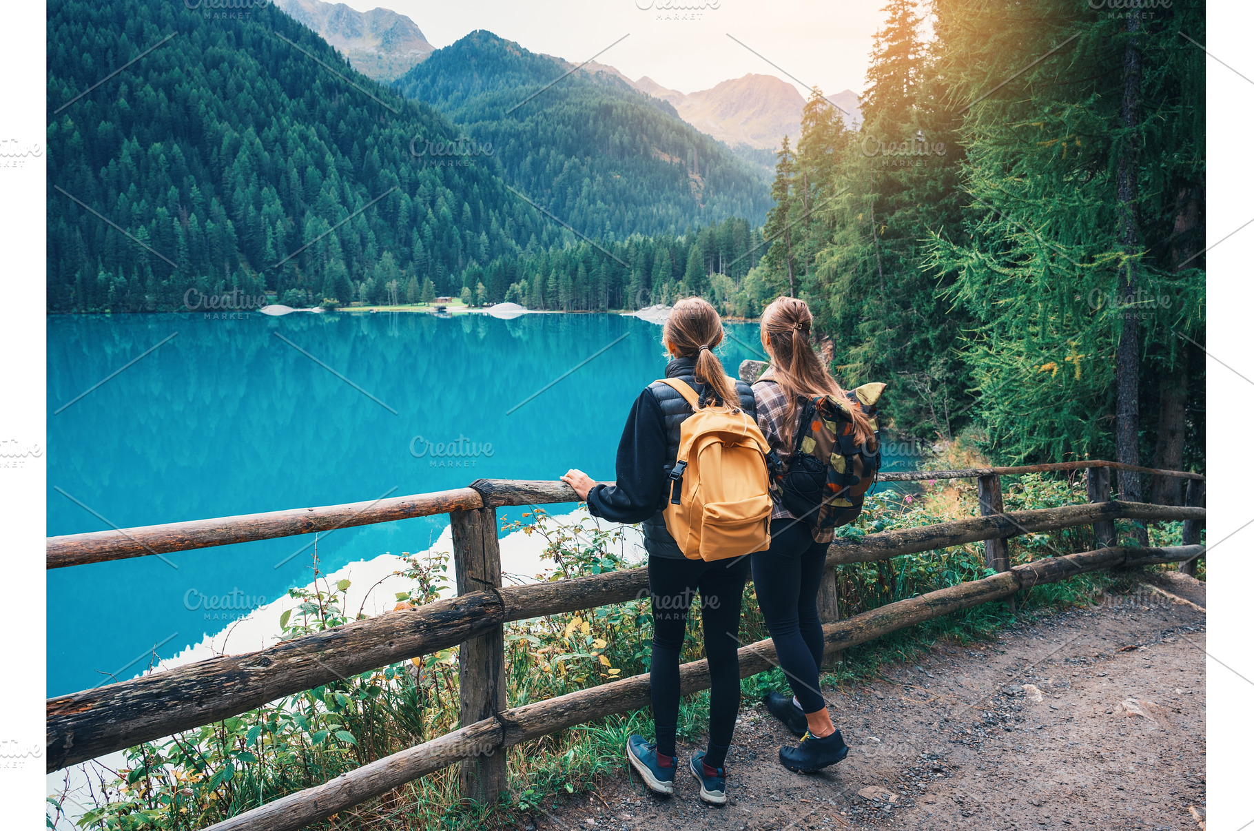 Two women with backpacks standing, a Nature Photo by den-belitsky