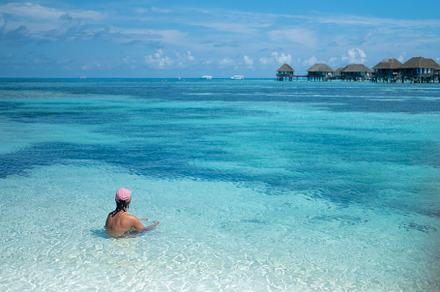 A man sits on the beach with amazing