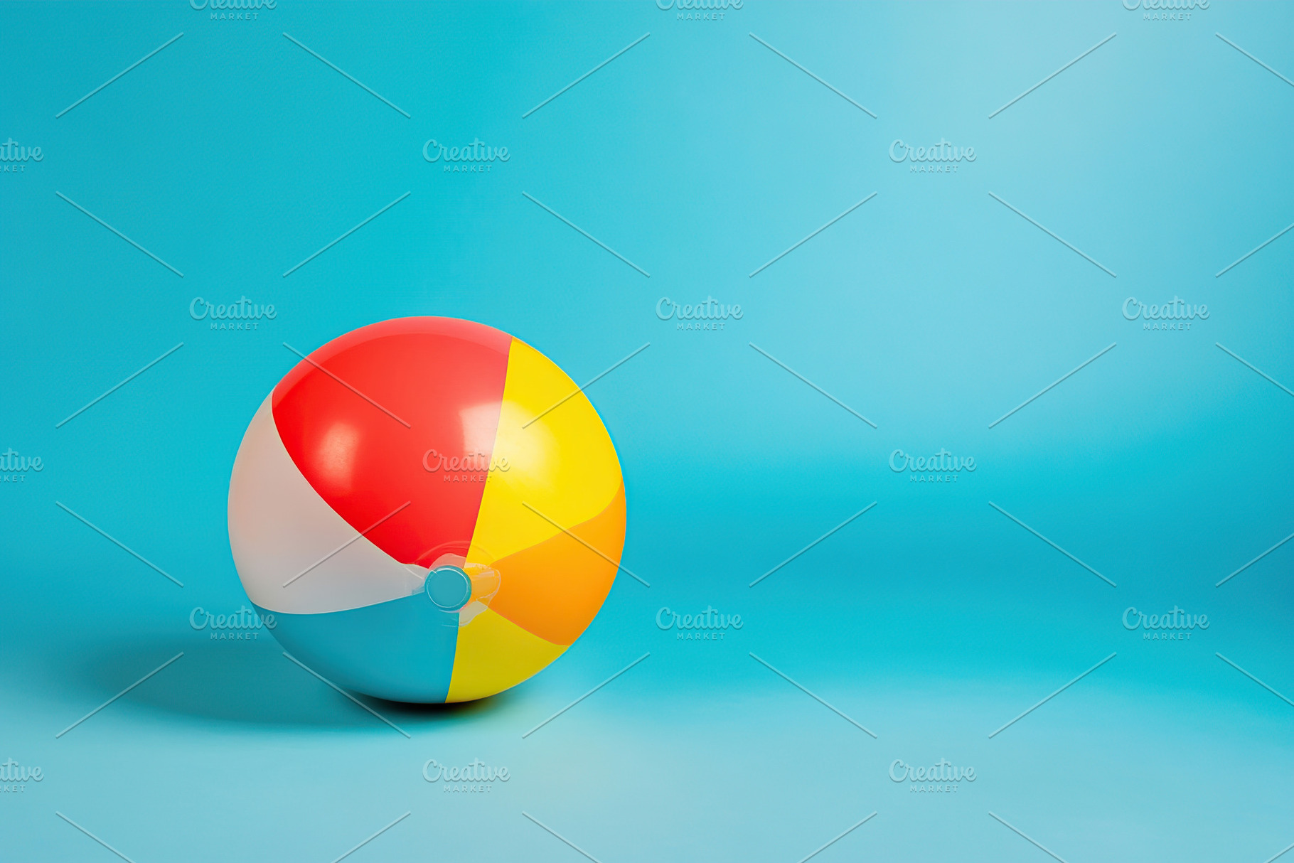 Colorful beach ball resting on pastel blue background enhances summer vibes and, a Sports & Recreation Photo by AlyaAnd