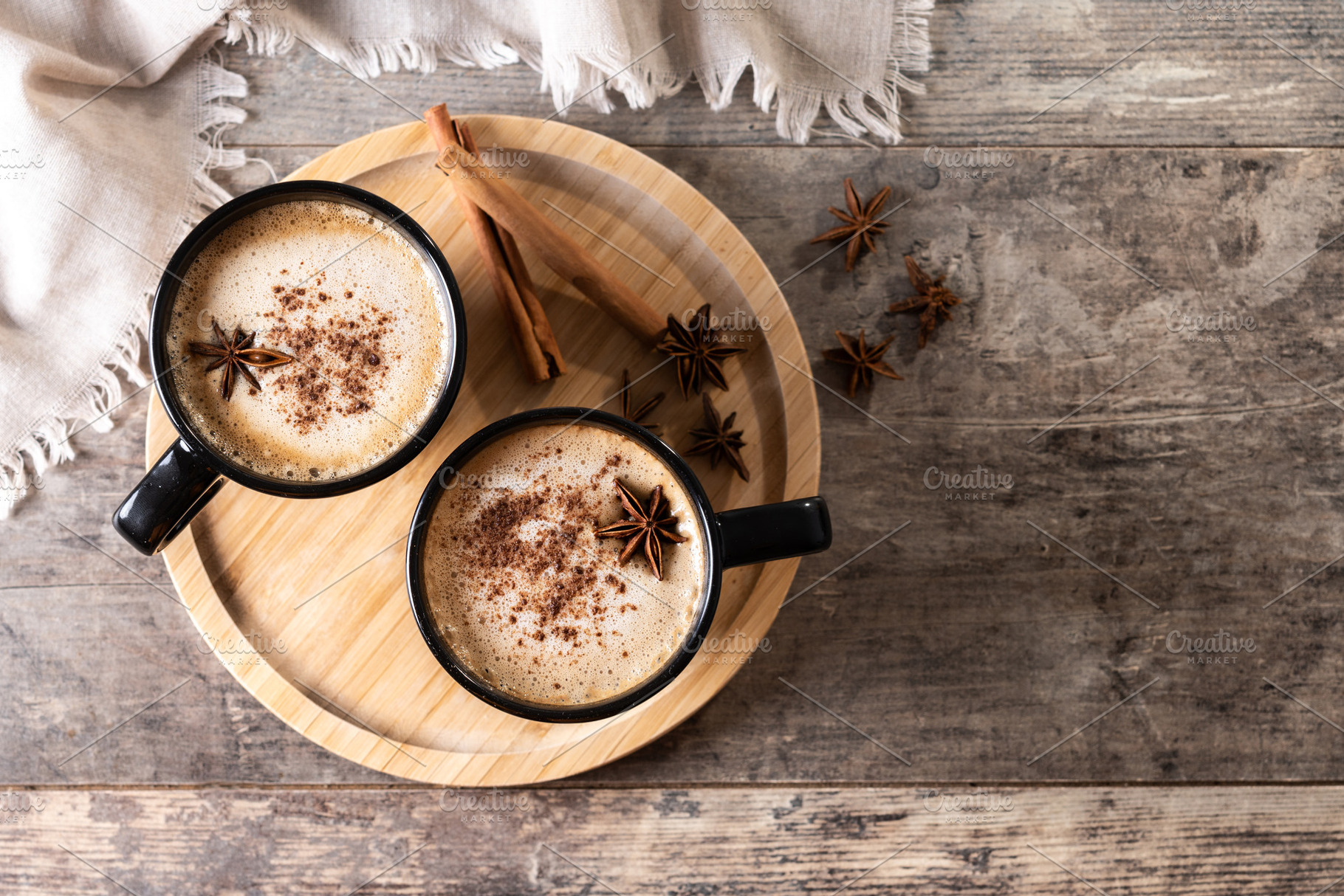 Chai Latte in Black Mug with Spices( star anise and cinnamon) on wooden table, a Food & Drink Photo by etorres69