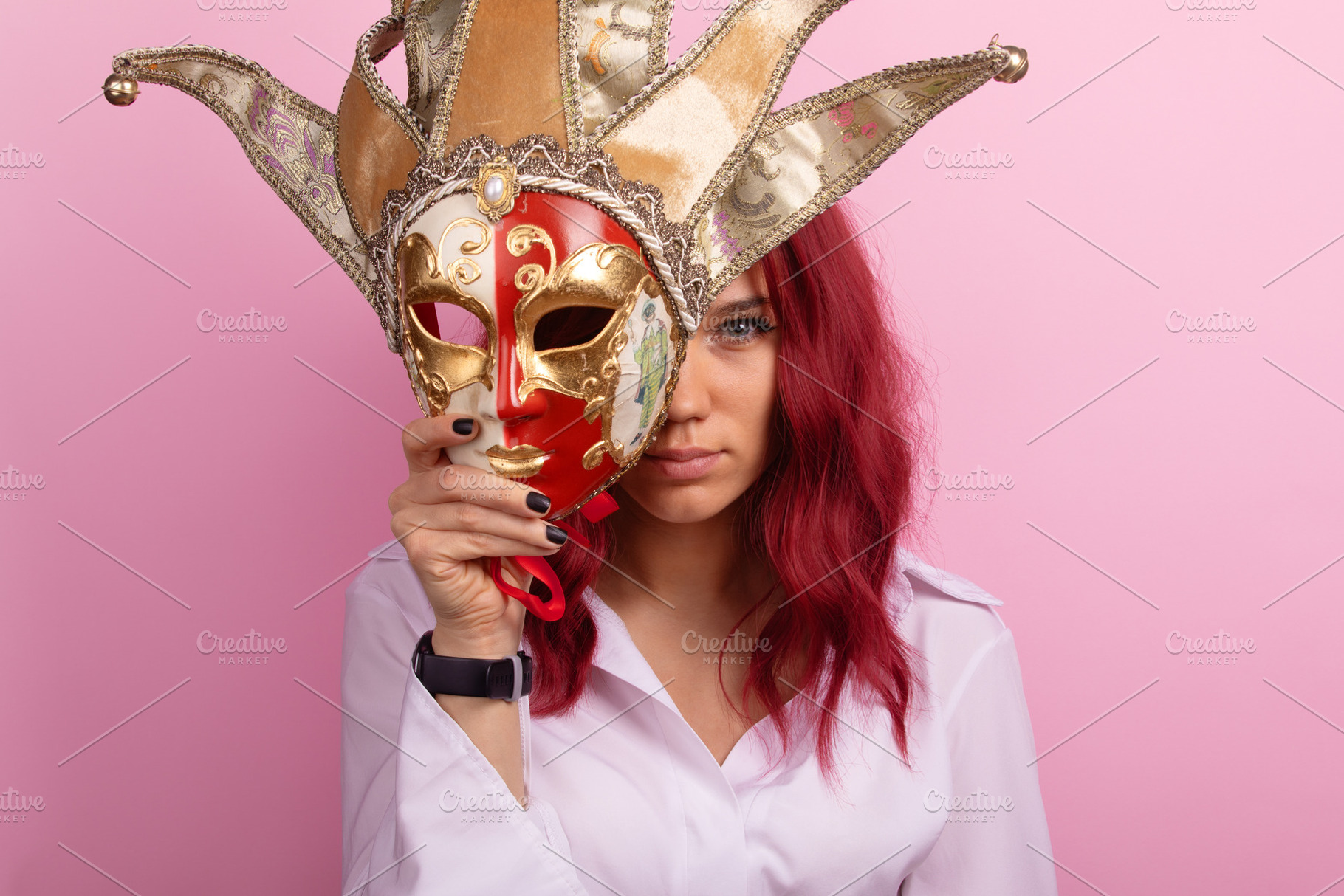 Confident woman with red hair holds ornate Venetian jester mask, a Person Photo by Ales Munt