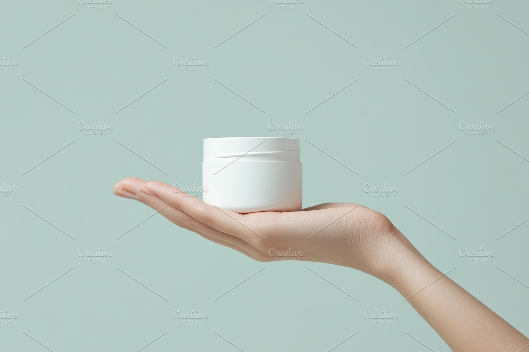 Female model hand holding cosmetic jar on grey background, a Health & Medical Photo by AlyaAnd