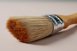 Close-up of a professional paintbrush with a wooden handle and soft bristles, p, a Business Photo by ImageMir