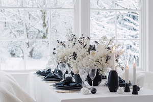 Elegant winter holiday table setting with white floral centerpie, a Photo by Studio ANNA