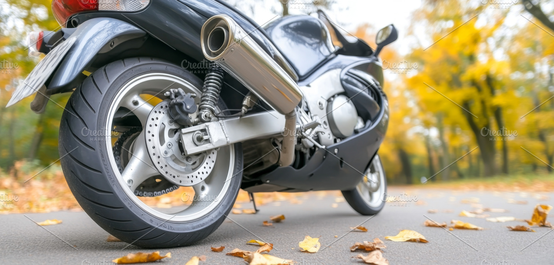 Motorcycle rear wheel close-up on asphalt road in autumn, a Photo by Dvoevnore photos