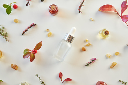 Bottles of essential oil with fresh thyme, wintergreen, frankinc
