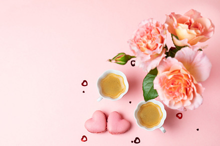 Romantic setup with coffee, macarons and roses