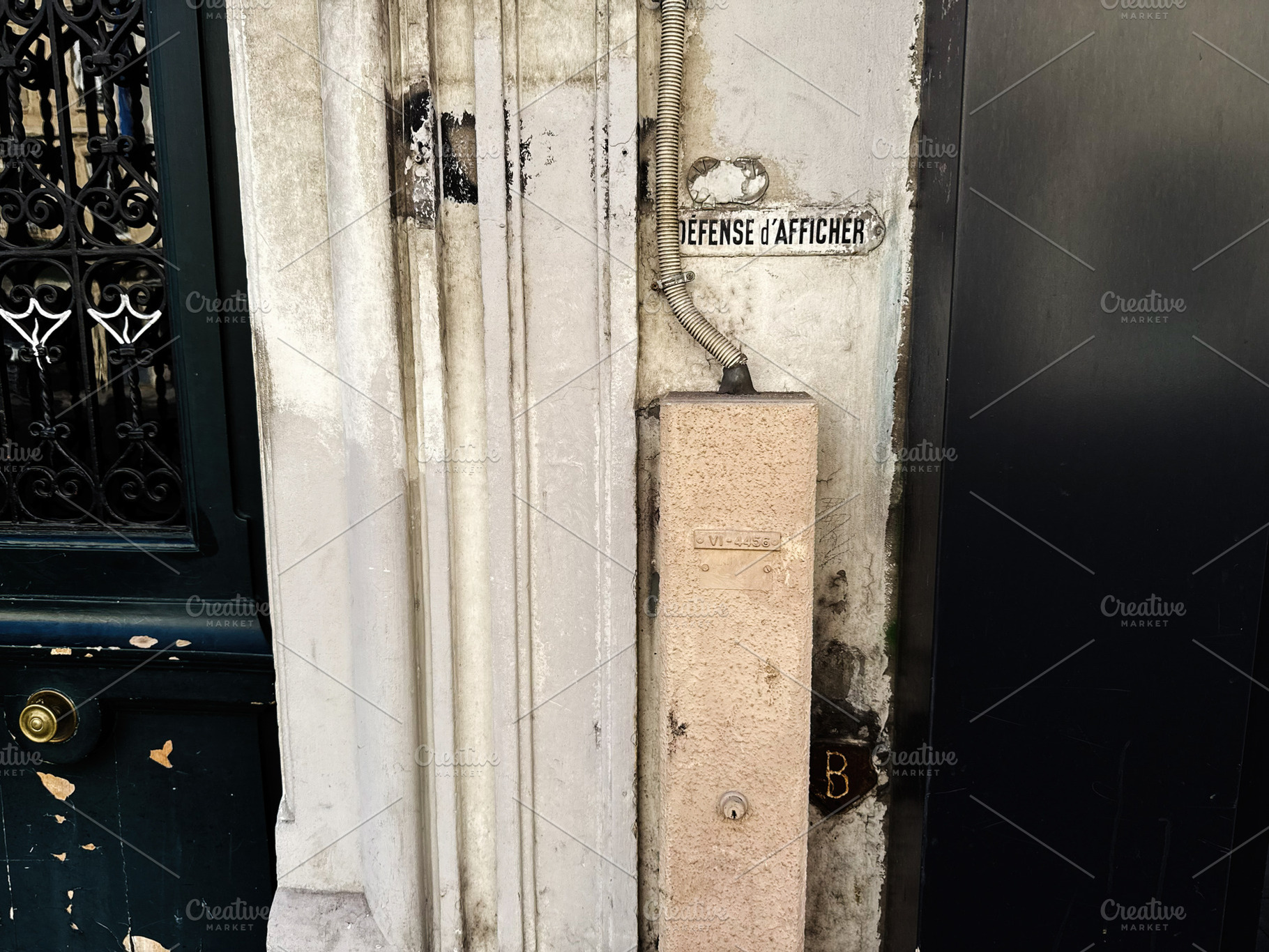 Weathered doorway and vintage sign on a Paris, France building wall with textur, a Photo by AS photostudio