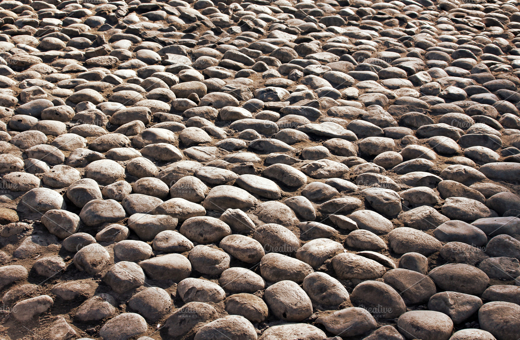 Old grunge grey cobble stone, a Photo by saiko3p