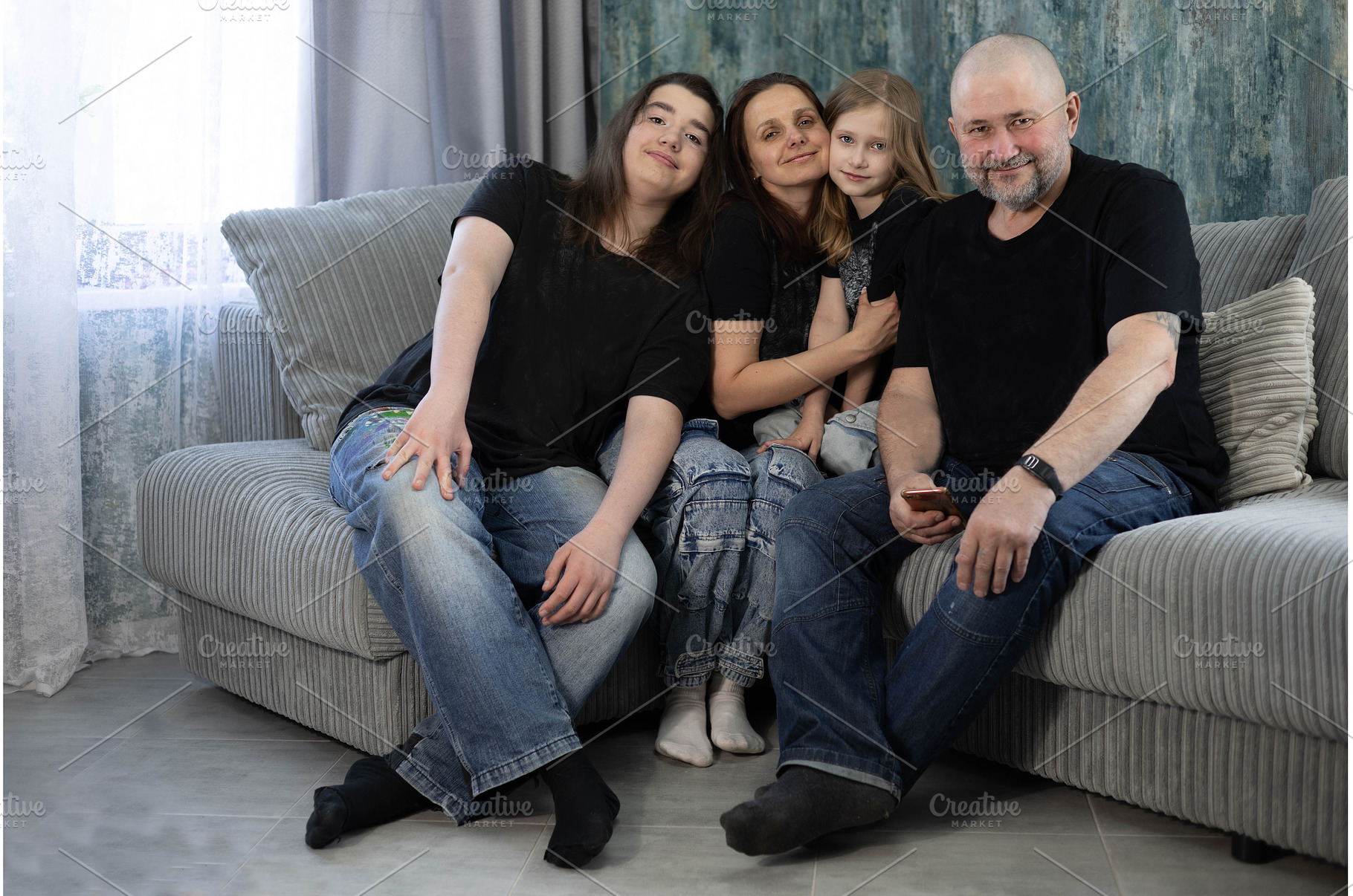 Family on the couch in black t, a Person Photo by Nenahliadava Design