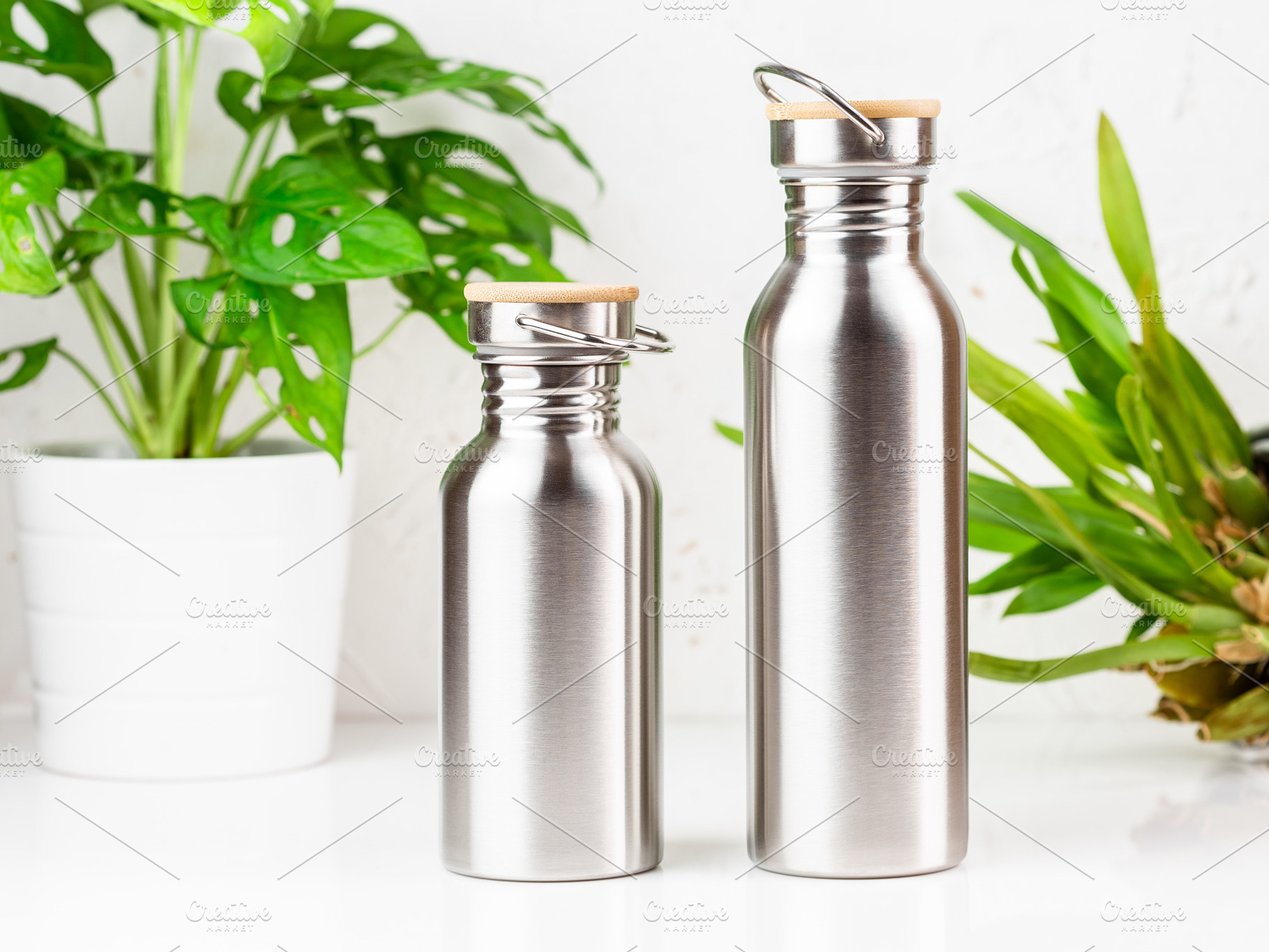 Two stainless steel water bottles, a Food & Drink Photo by Andriana Syvanych