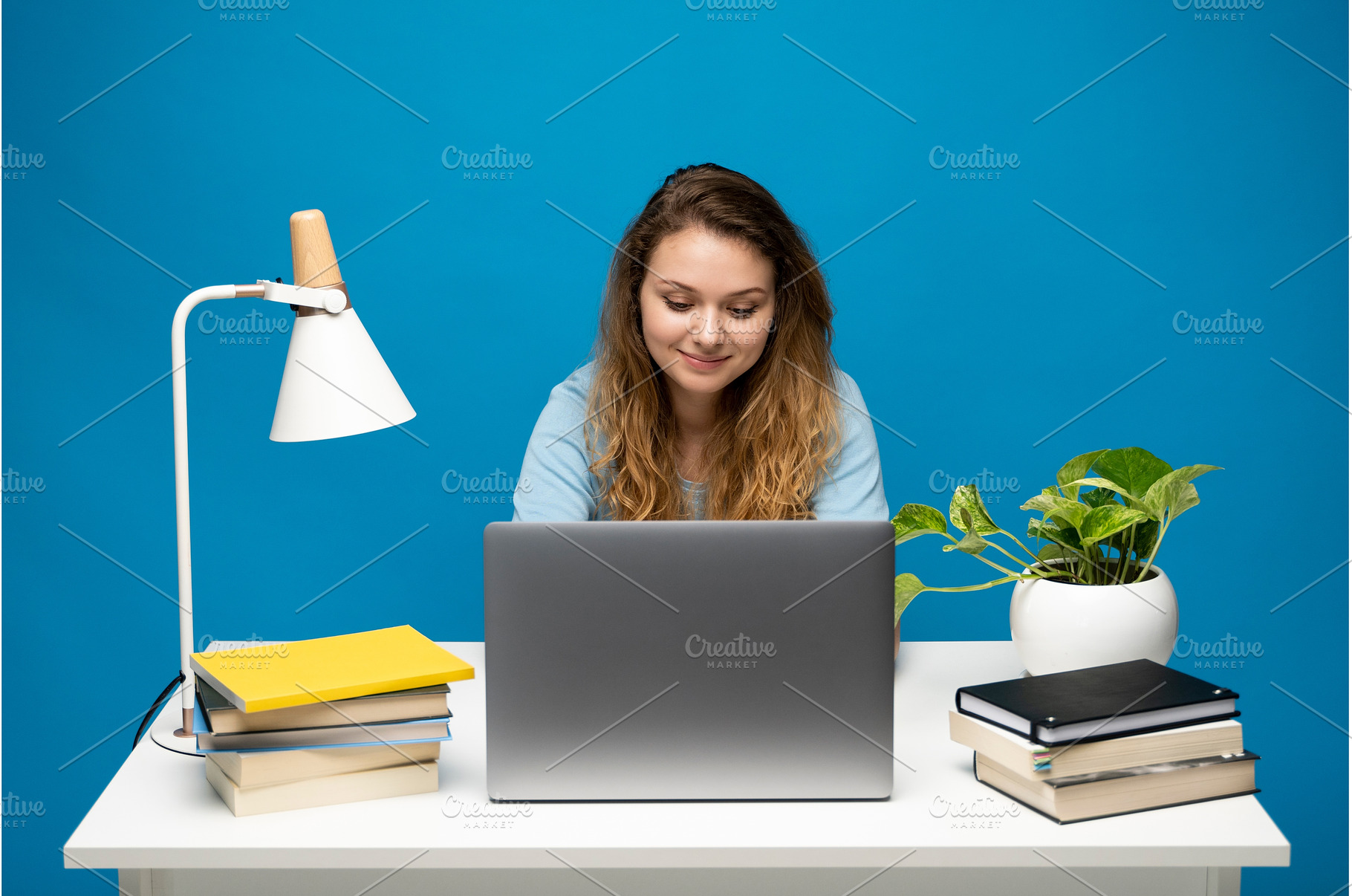 Focused woman working at desk with, a Person Photo by volodymyrshtun13795