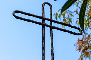 Cross made of reinforcing steel bars standing on a stone, a Photo by Antonio Gravante Market
